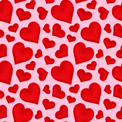 Seamless pattern made of red hearts. Creative concept on a pink background.