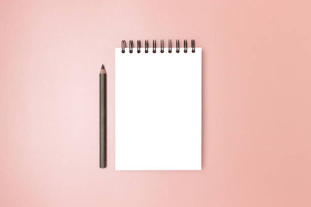 istock Empty notepad mockup and pencil on a pink shiny background. 1445200186