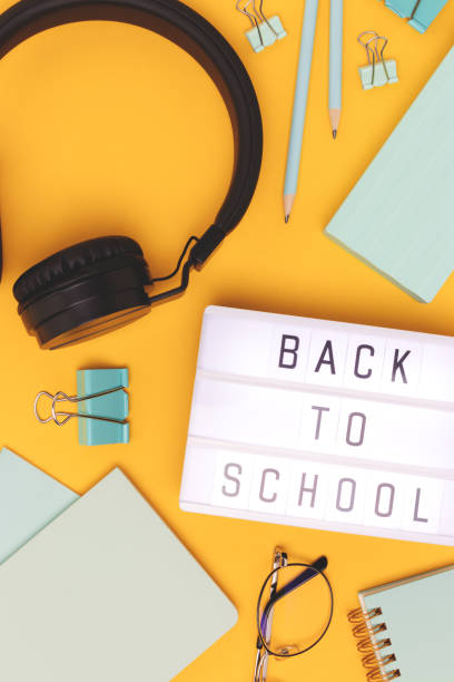 istock Back to school. Lightbox with letters, headphones and stationery. 1445201182