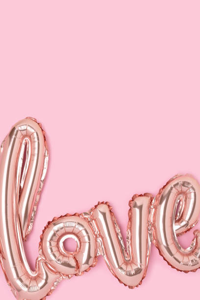 istock Word Love. Foil inflatable balloon on a pink background. 1445201602