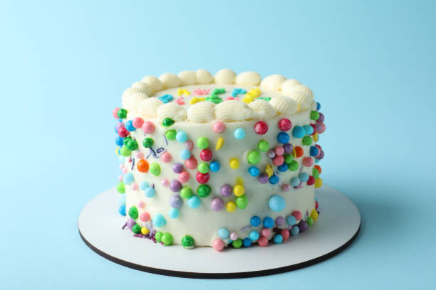 istock Cute bento cake with tasty cream on light blue background 1445201956