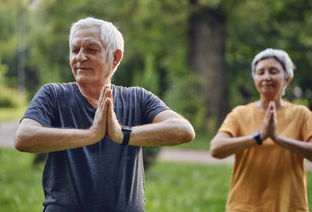 istock Older active couple do meditation practice outdoors 1445202119