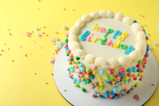 istock Cute bento cake with tasty cream on yellow background, space for text 1445202235