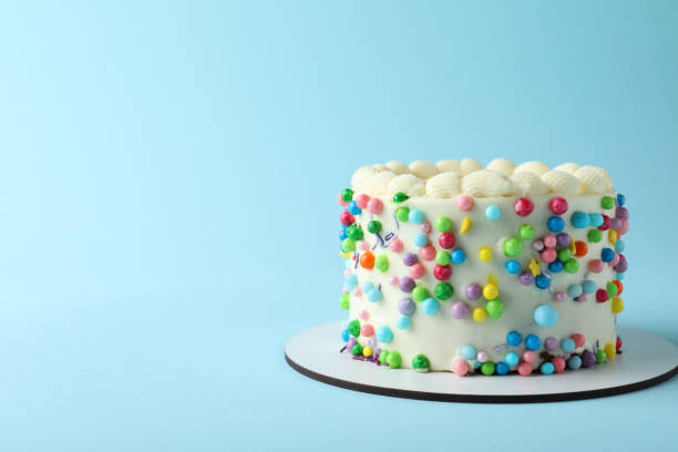 istock Cute bento cake with tasty cream on light blue background, space for text 1445202238