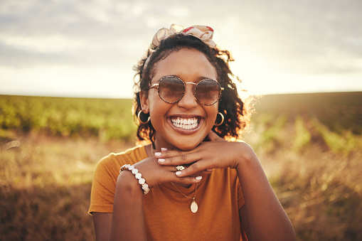 Face smile, black woman and countryside sunglasses, summer vacation or holiday. Portrait, travel and happy female from Brazil having fun outdoors, freedom and relax in nature enjoying time alone.