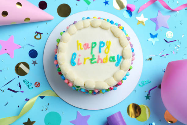 Cute bento cake with tasty cream and decor on light blue background, flat lay
