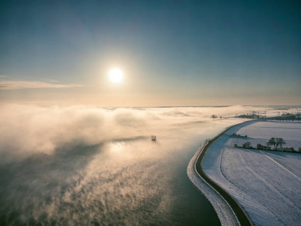 A beautiful aerial photograph of a sunrise over the steam rising from Lake Michigan during the polar vortex of winter 2019 with subzero temperatures at the snow covered Foster Beach.