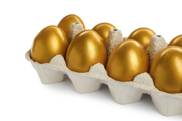 istock Many shiny golden eggs in carton on white background 1445202998