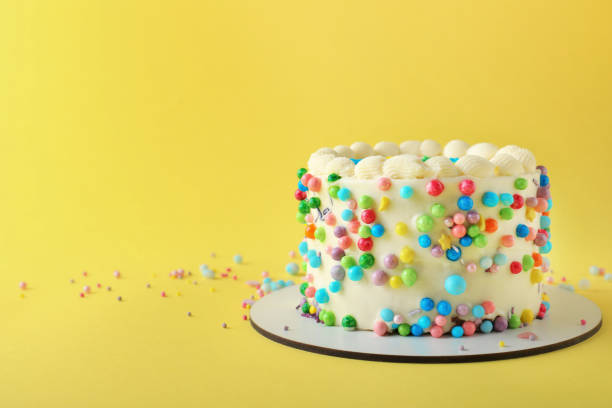 istock Cute bento cake with tasty cream on yellow background, space for text 1445203364