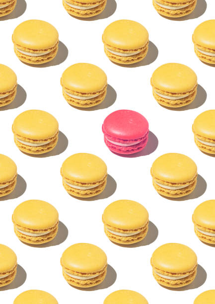 istock Pattern  with yellow macarons and white background. Equal macarons minus one. Concept of being different o unique 1445207417