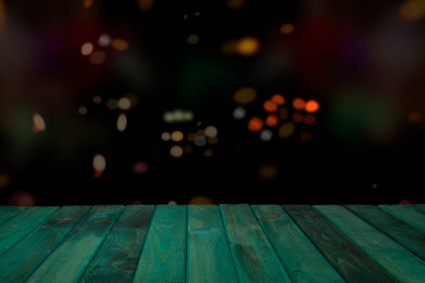 istock Green wood podium with sparkles and celebration theme lights effect on background 1445207487