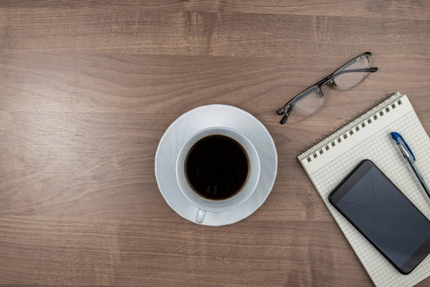istock Work table with a cup of coffee and supplies for work, top view, space for text 1445209828