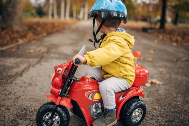 istock Little boy riding toy motorcycle 1445211548