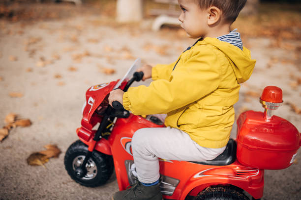 istock Little boy riding toy motorcycle 1445211788