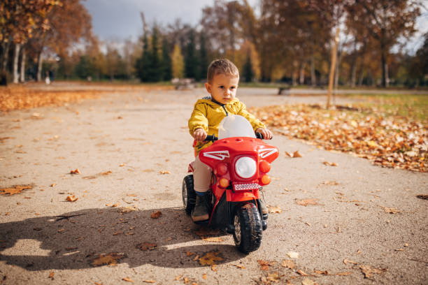 istock Little boy riding toy motorcycle 1445211825