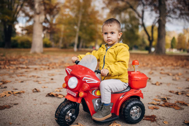 istock Little boy riding toy motorcycle 1445212496