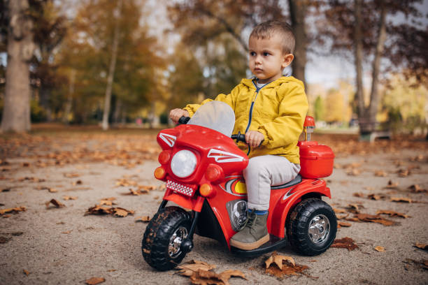istock Little boy riding toy motorcycle 1445212595