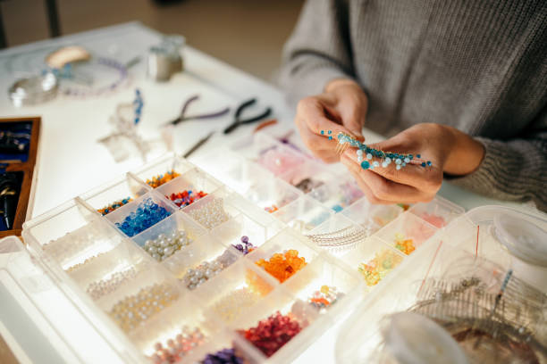 istock Woman making bead jewelry at home 1445212737