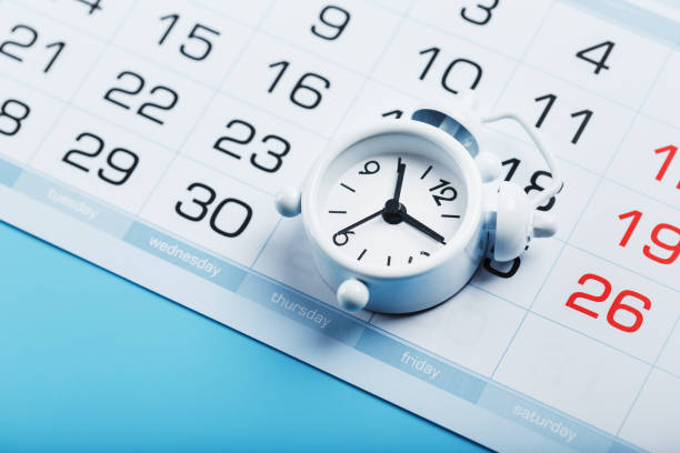 istock Alarm clock and calendar on a blue background 1445212744