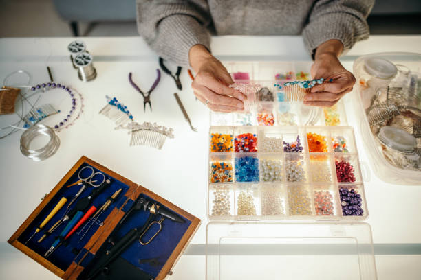 istock Woman making bead jewelry at home 1445212766