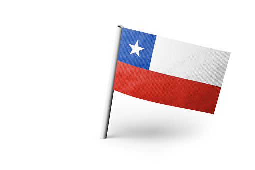 Small paper flag of Chile pinned. Isolated on white background. Horizontal orientation. Close up photography. Copy space.