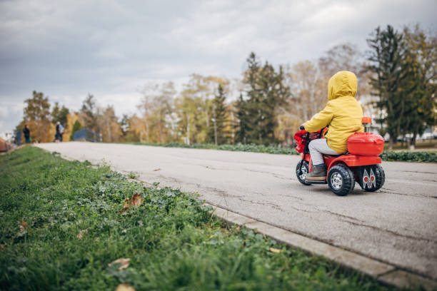 istock Little boy riding toy motorcycle 1445213232