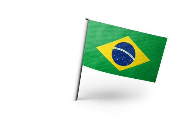 Small paper flag of Brazil pinned. Isolated on white background. Horizontal orientation. Close up photography. Copy space.