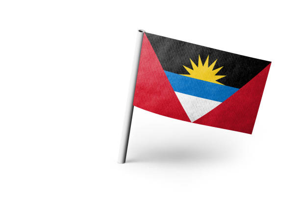 Small paper Antigua and Barbuda flag pinned. Isolated on white background. Horizontal orientation. Close up photography. Copy space.