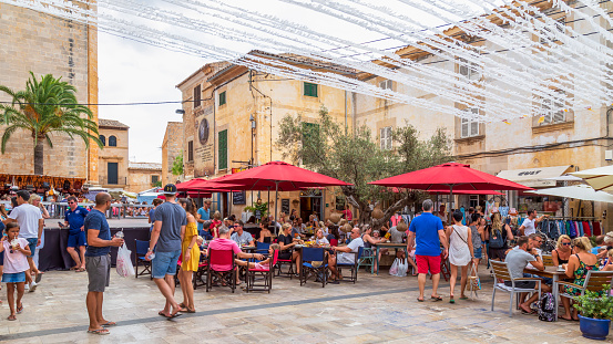 Santanyí, Spain, July 21, 2018; Cozy small square with terraces in the picturesque town of Santanyí on the Mediterranean island of Mallorca in Spain.