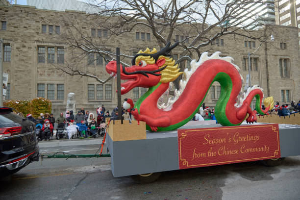 A Chinese parade float. Toronto Ontario, Canada- November 20th, 2022: A Chinese parade float that is giving seasons greetings during Toronto’s annual Santa Claus parade. festival float stock pictures, royalty-free photos & images