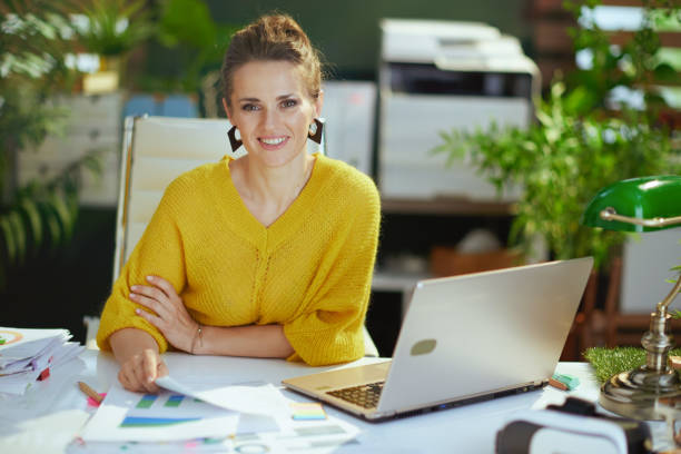 istock business owner woman in green office working with documents 1445215246
