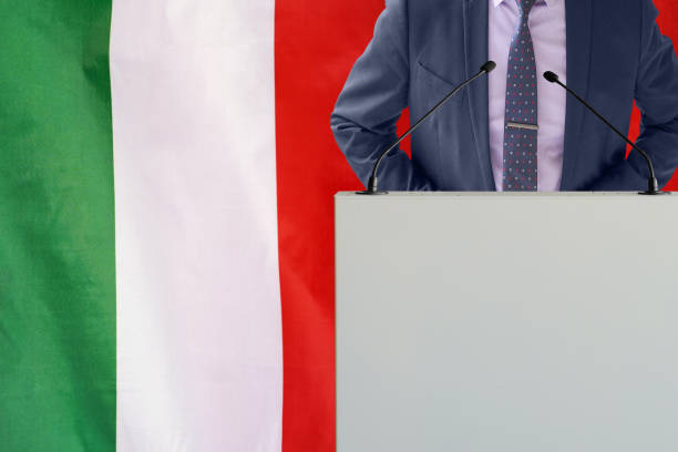 political personality standing on the stage for conference on italy flag background. male speaker in italy - foton med speaker bildbanksfoton och bilder