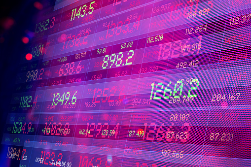 Financial Data. Abstracted finance screens. Bright lights and reflections in background.