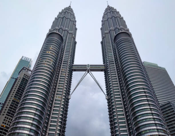 KLCC Malaysia twin tower with blue sky bridge Petronas skyscrapers famous tourist visit icon business trip KLCC Petronas Twin Tower Malaysia menara kembar Asia sky blue horizontal view buildings icon tallest tourist silver signature landmark business travel city skyline outdoor twin towers malaysia stock pictures, royalty-free photos & images