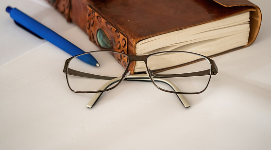 Reading glasses and book on the table