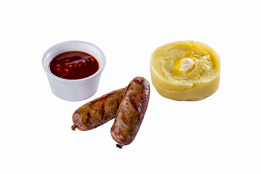 Grilled pork sausages with mashed potatoes and sauce on isolated white background