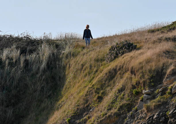 Erquy, France, September 20, 2022 - Silhouette of walkers on a cliff of Cap d'Erquy