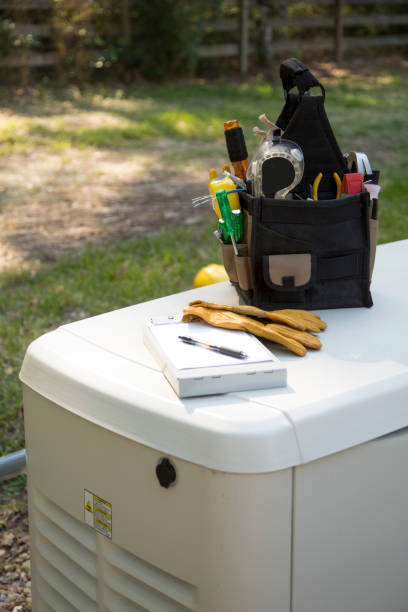 istock Blue collar tools on top of a home generator.   Tool bag with tools, safety gloves and invoice clipboard. 1445222398