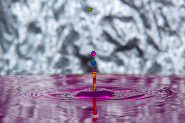 istock Colorful water drop making ripple on the water surface. 1445224783