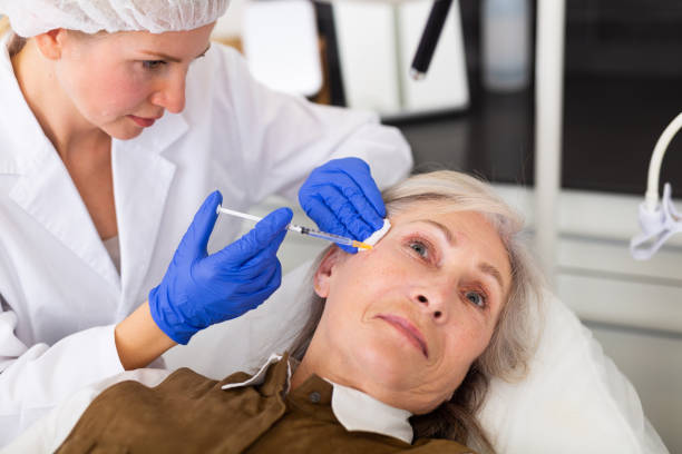 istock Cosmetologist doing botulotoxin injections for senior woman 1445231453