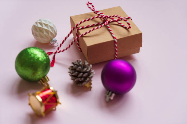 Christmas decoration made with ornaments on pink background