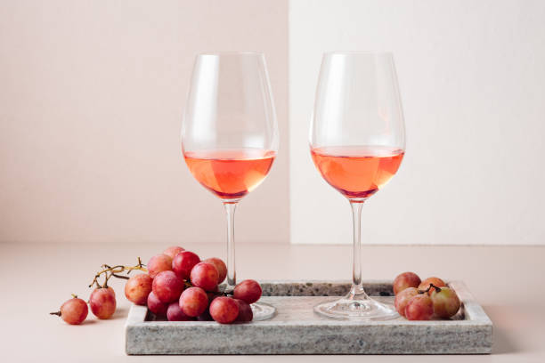 istock Two glasses of rose wine and red grapes. 1445231583