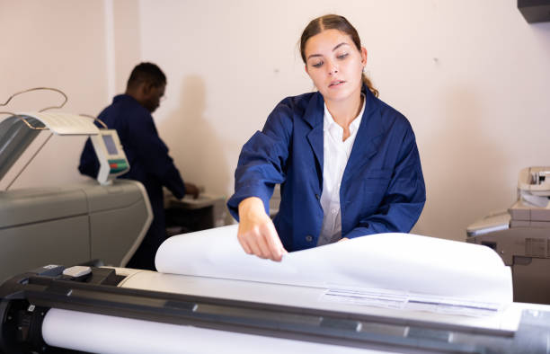 istock Female worker in a printing and press centar check print quality 1445233254