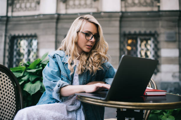 istock Smart woman typing on laptop in outside cafe 1445233647