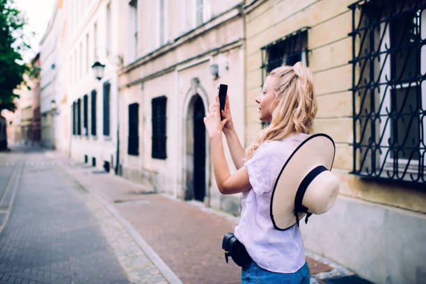 istock Pensive female photographing old town 1445233860