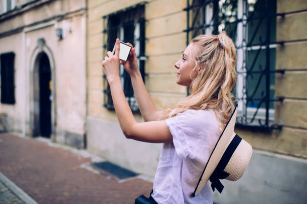 istock Delighted female photographing building exterior 1445234361
