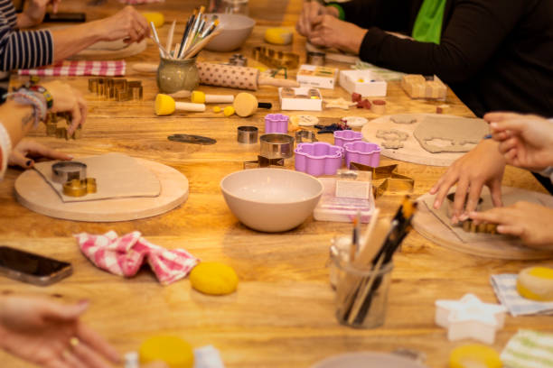 Christmas pottery workshop. People working the pottery to make ornaments.