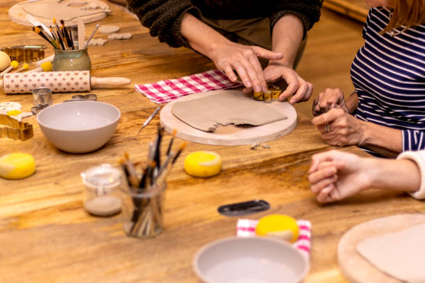 istock Christmas pottery workshop. Teacher teaching how to work to his students. 1445237629