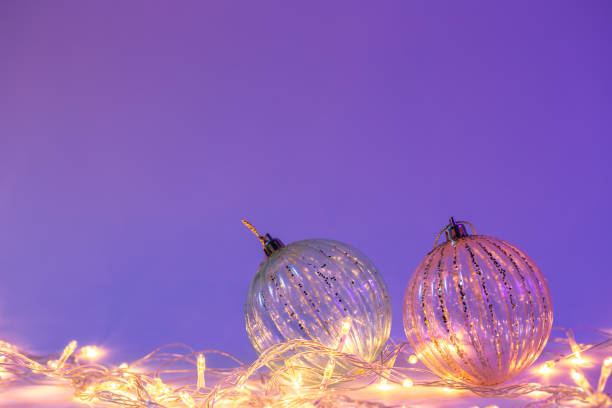 istock Christmas tree balls and garland in neon light isolated, copy space. 1445238139