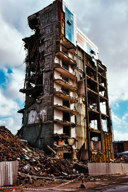 Old building being demolished to make room for new architecture. Construction Demolition Site. Destroyed building, can be used as demolition, earthquake, bomb, terrorist attack or natural disaster